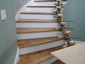 Treads installed, Banister being cured into stair curvature after water soak