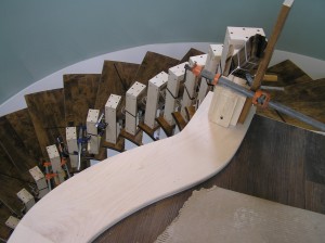 Treads installed, Banister being cured into stair curvature after water soak