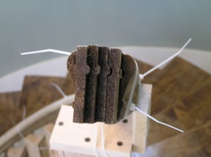 End of stair rail showing laminated sections to allow bending into curve rail
