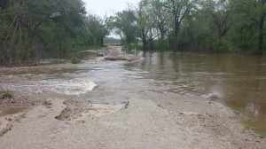 Water flowing over road, cut road base about 1 foot